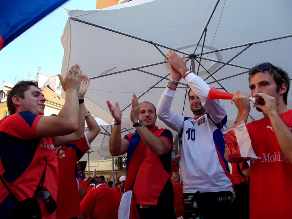 Czech supporters waving flags in a football crowd