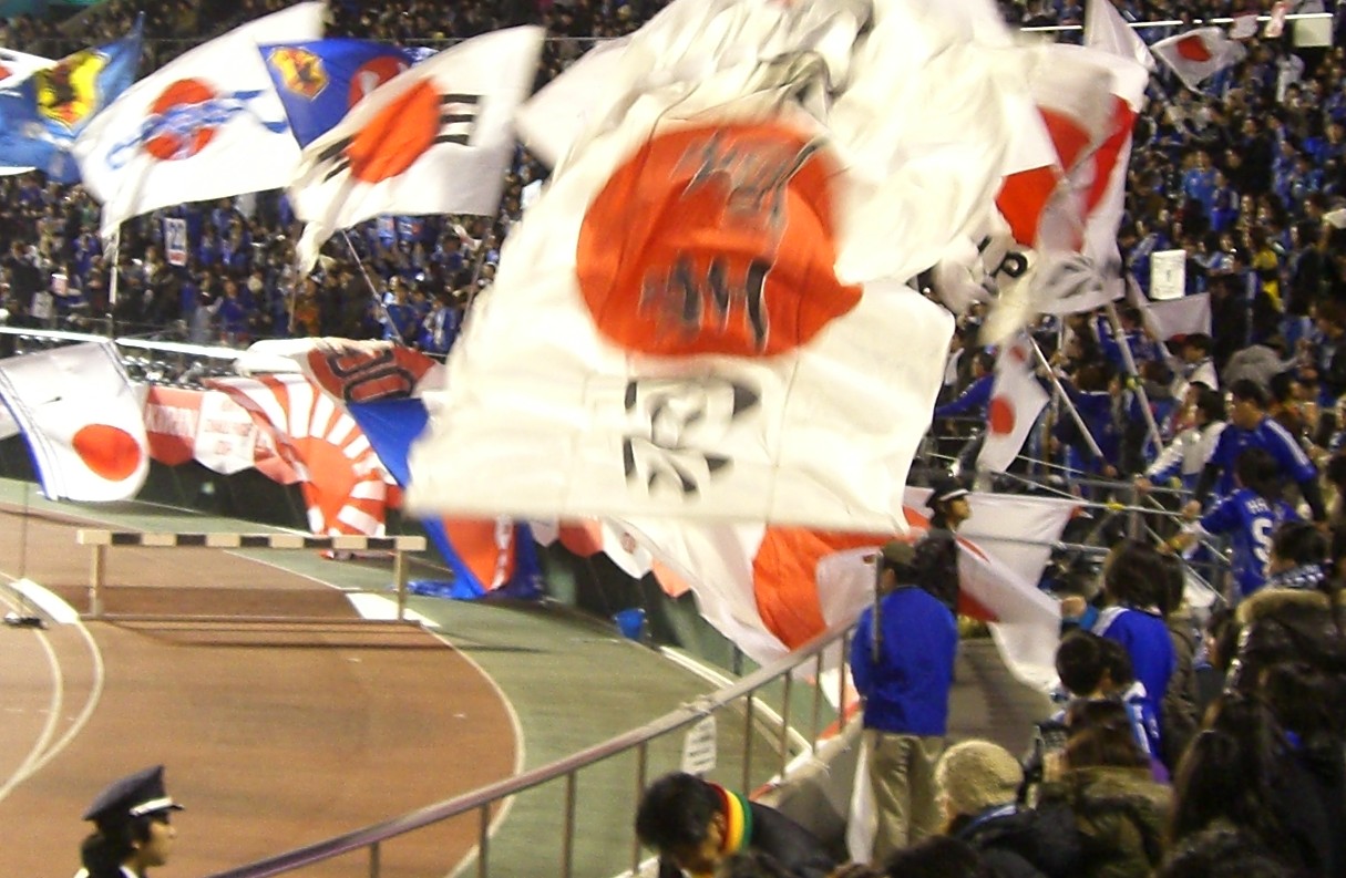 Japan supporters holding flags before an international football match