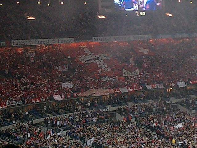 Switzerland supporters with red flags and scarves in a football crowd